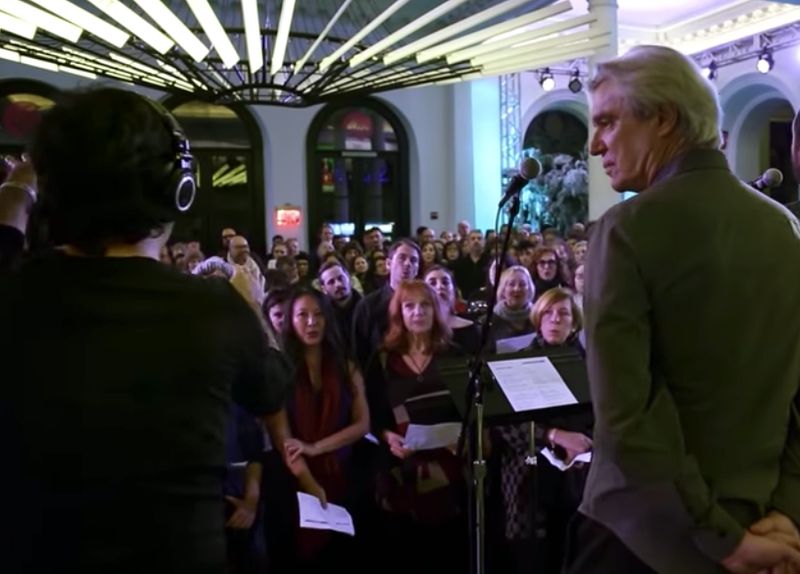 David Byrne performs an emotional cover of David Bowie’s ‘Heroes’ with a huge choir