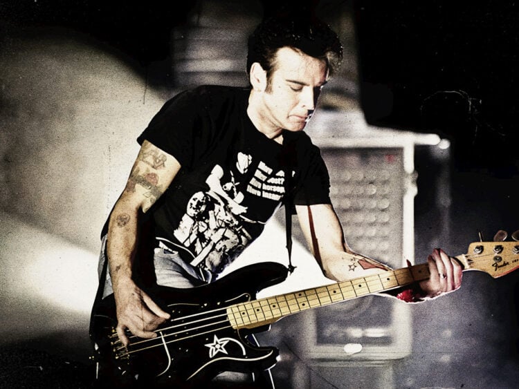 Simon Gallup performing with The Cure in 2012